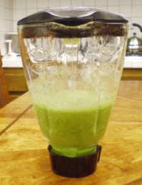 green tropical frozen smoothie drink in blender